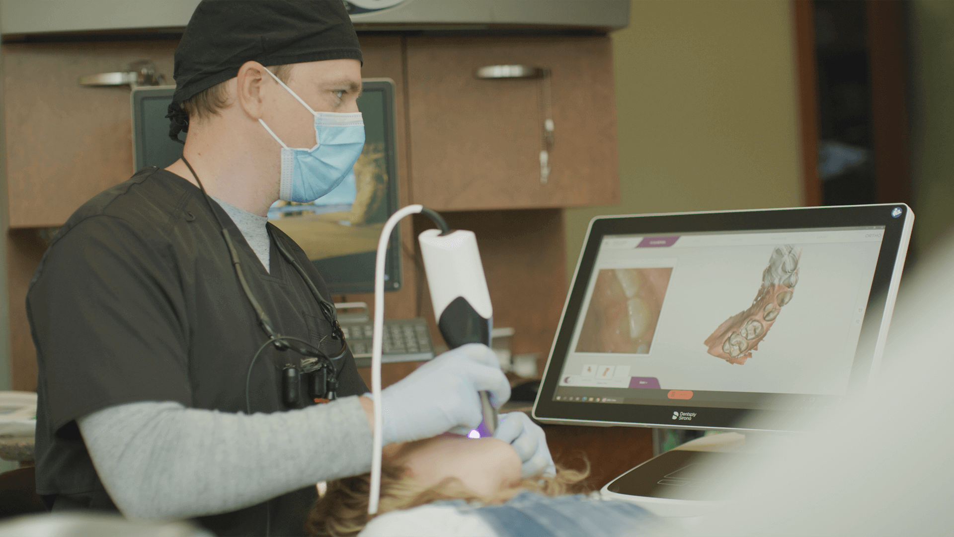 Dentist taking a digital image of a girl's mouth